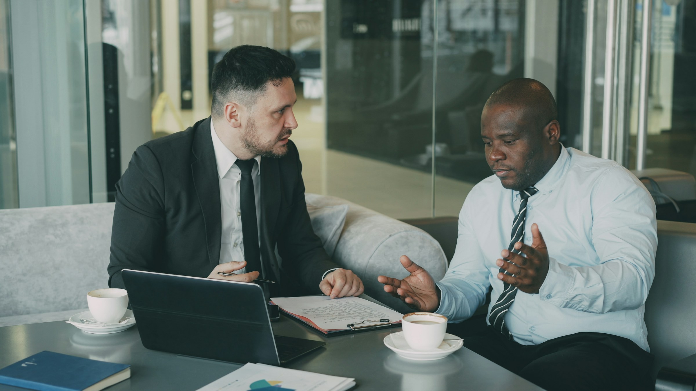 Two people putting documents and charts on a table